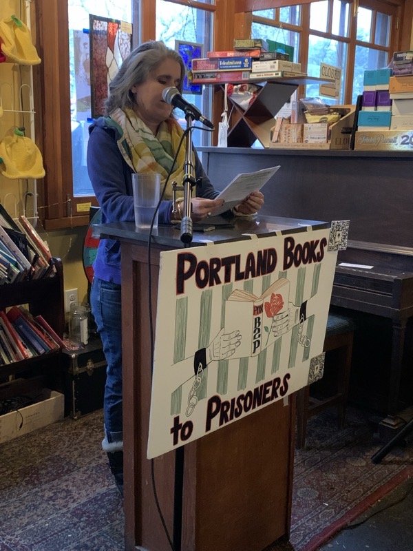 Deanna Cintas, President of Books Through Bars Portland, addresses the group of supporters at Rose City Book Pub.